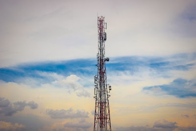 Low angle view of communications tower against sky