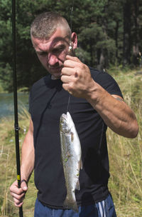 Man holding fish on field