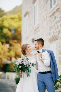 View of couple holding bouquet