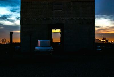 View of buildings against cloudy sky at sunset