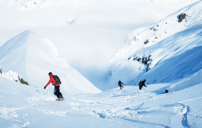 People skiing on snowcapped mountain