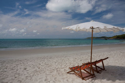 Lifeguard hut on beach against sky