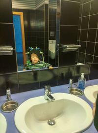 Reflection of man in bathroom