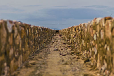 Surface level of footpath against sky