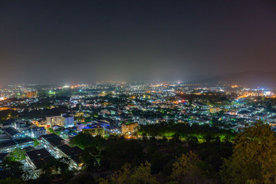 High angle view of illuminated buildings in city at night