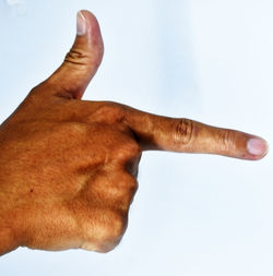 Close-up of man hand against white background