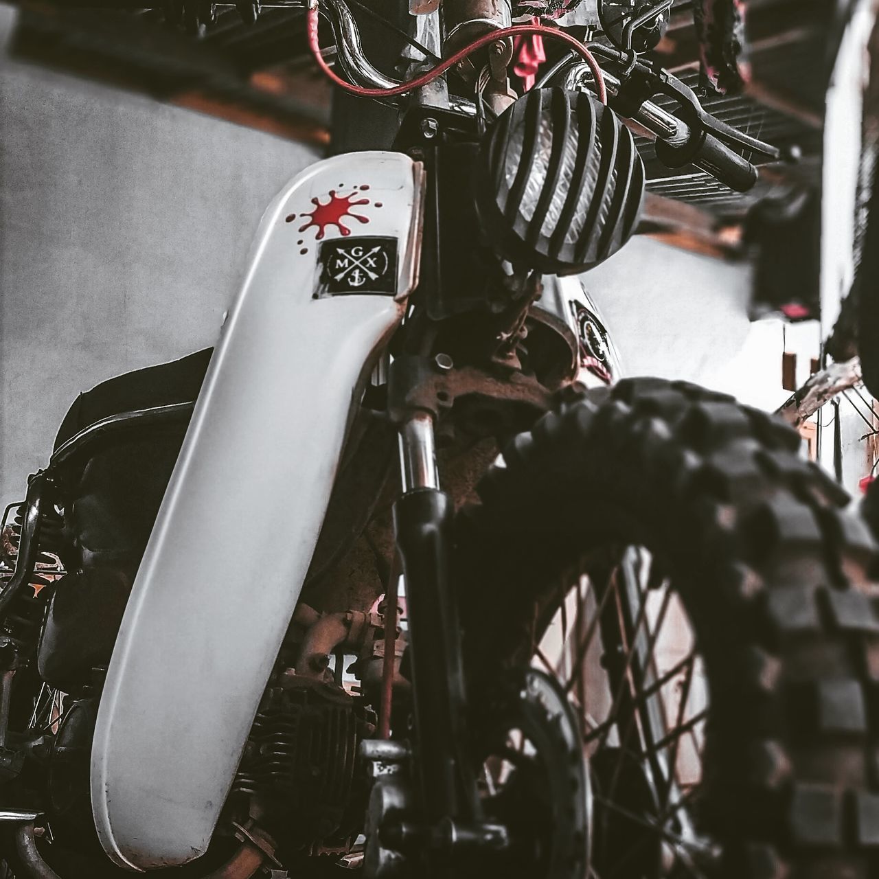 bicycle, mode of transportation, transportation, stationary, land vehicle, motorcycle, no people, parking, metal, travel, selective focus, handlebar, close-up, focus on foreground, day, handle, outdoors, wheel, garage