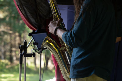 Midsection of man holding bicycle