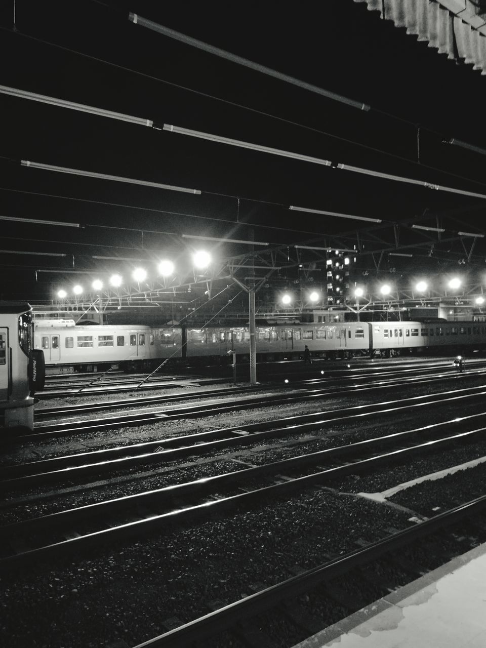 ILLUMINATED RAILROAD TRACKS AGAINST SKY