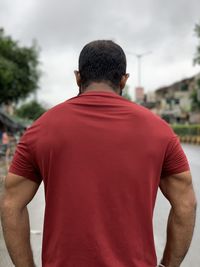 Rear view of man standing against blurred background