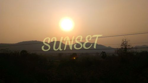 Information sign on landscape at sunset