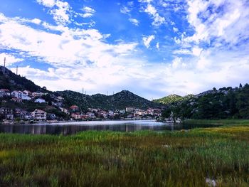 Scenic view of lake and mountains against sky