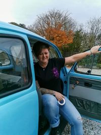 Portrait of woman sitting in car