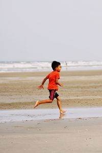 Boy running at beach