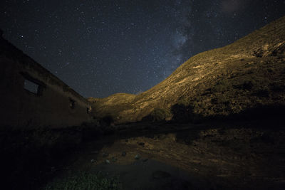 Scenic view of mountains against sky at night