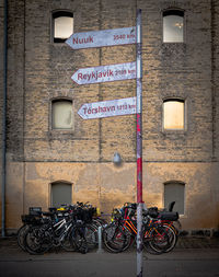 Low angle view of colorful bicycles against historical building  
