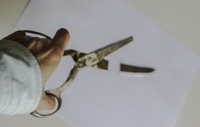Close-up of human hand holding paper