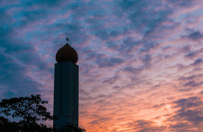 Low angle view of building against cloudy sky