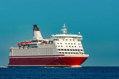 View of ship in sea against clear blue sky