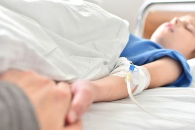 Midsection of woman lying on bed