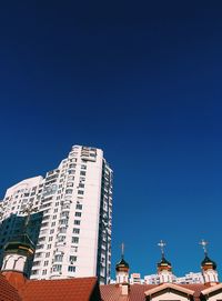 Low angle view of buildings against blue sky