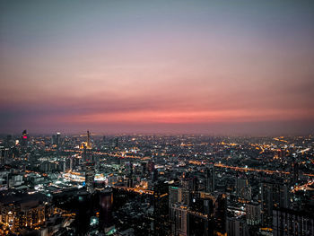 High angle view of illuminated buildings against sky during sunset