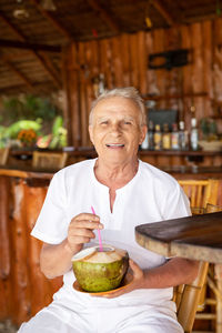 Portrait of senior man having food at restaurant