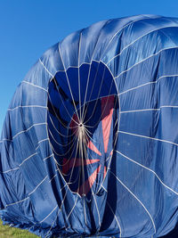 Low angle view of hot air balloon against blue sky