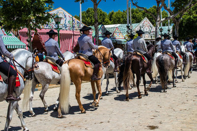 People riding horses on field