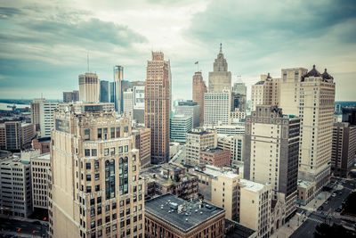 High angle shot of cityscape against clouds