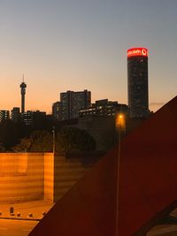 City buildings against sky during sunset