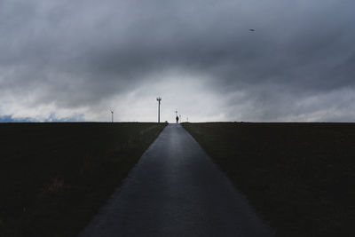 Road amidst land against sky