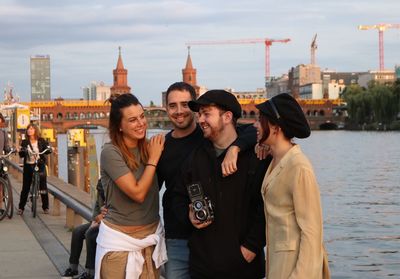 Young couple standing in city against sky