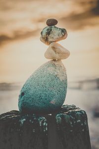 Close-up of stone stack on rock at beach