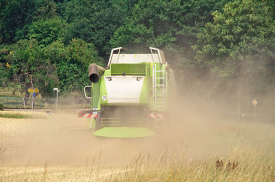 Combine harvester working on field