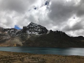 Scenic view of sea and mountains against sky