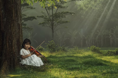 Portrait of girl playing violin on land