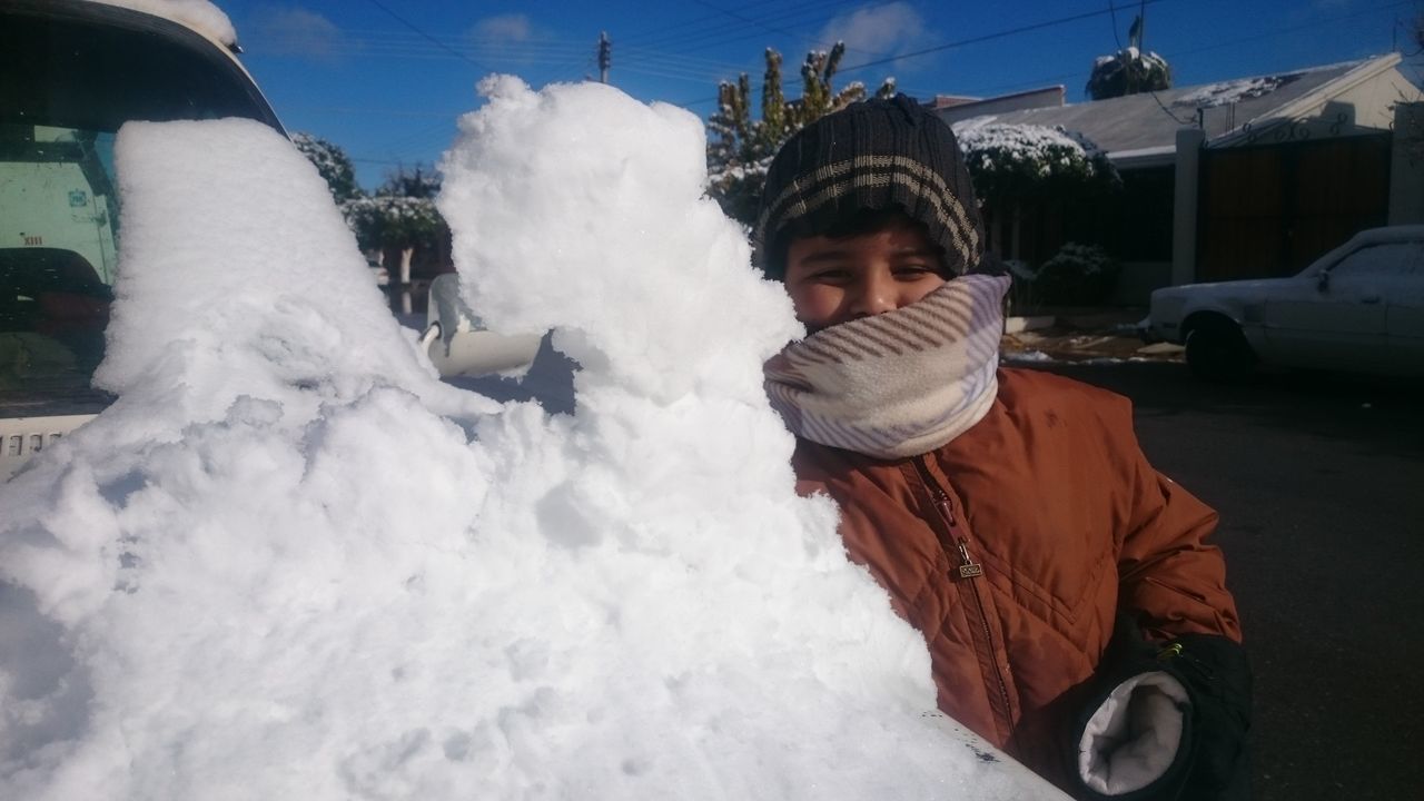 FULL LENGTH OF BOY STANDING ON SNOW COVERED LANDSCAPE