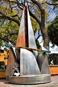 Close-up of sculpture against tree trunk