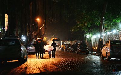 People walking on street in city at night