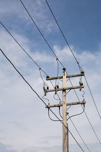 Low angle view of power line against sky