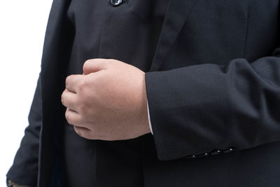 Midsection of man wearing mask against white background