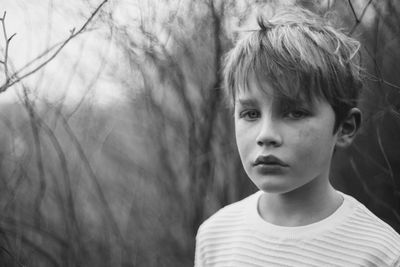 Close-up portrait of boy in forest