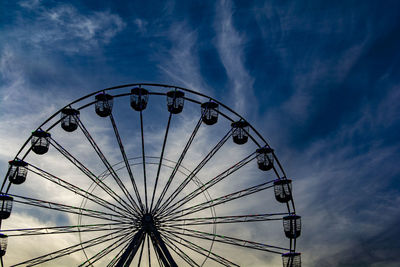 Low angle view of ferris wheel against sky