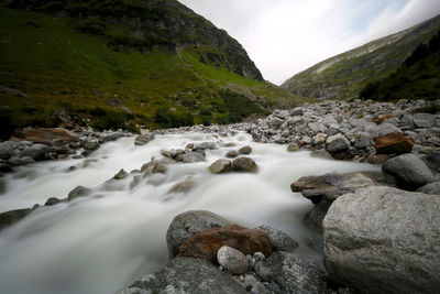 Scenic view of river flowing through rocks