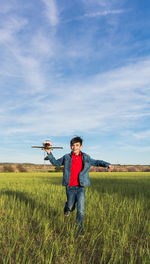 Man standing on field against sky