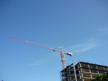 Low angle view of crane at construction site