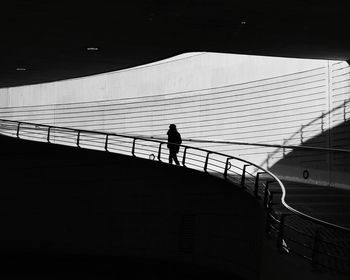 Silhouette person walking on staircase