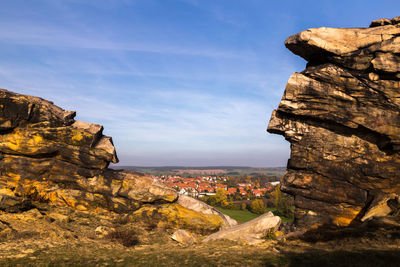 Rock formations by sea against sky