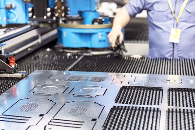 Man working at programmable cnc machine